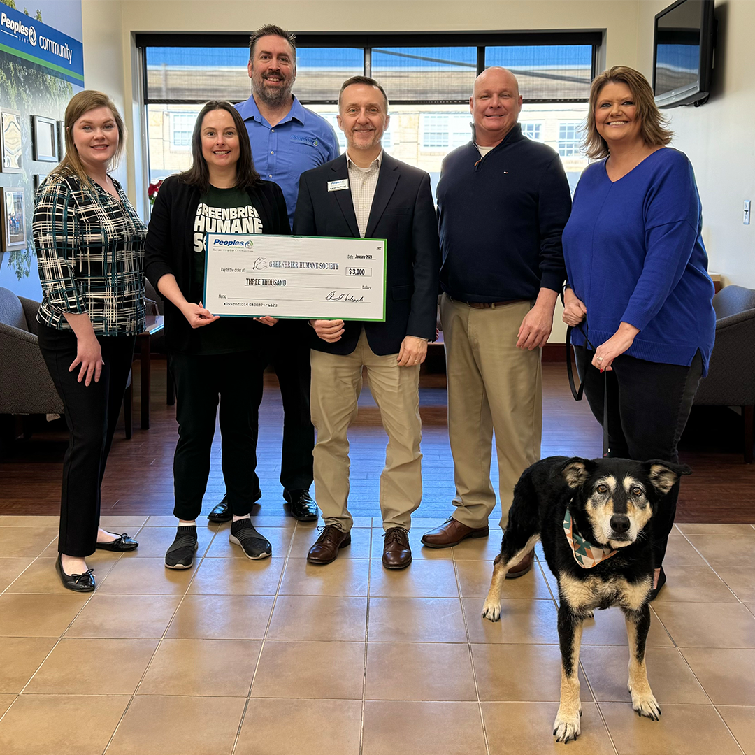Peoples Bank associates present a check to the staff of the Greenbrier Humane Society and a forever home dog